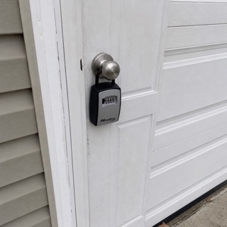 A Facilist list item: a lockbox photo with a voice note saying the spare key for the back door is inside, code 4-7-2-2.